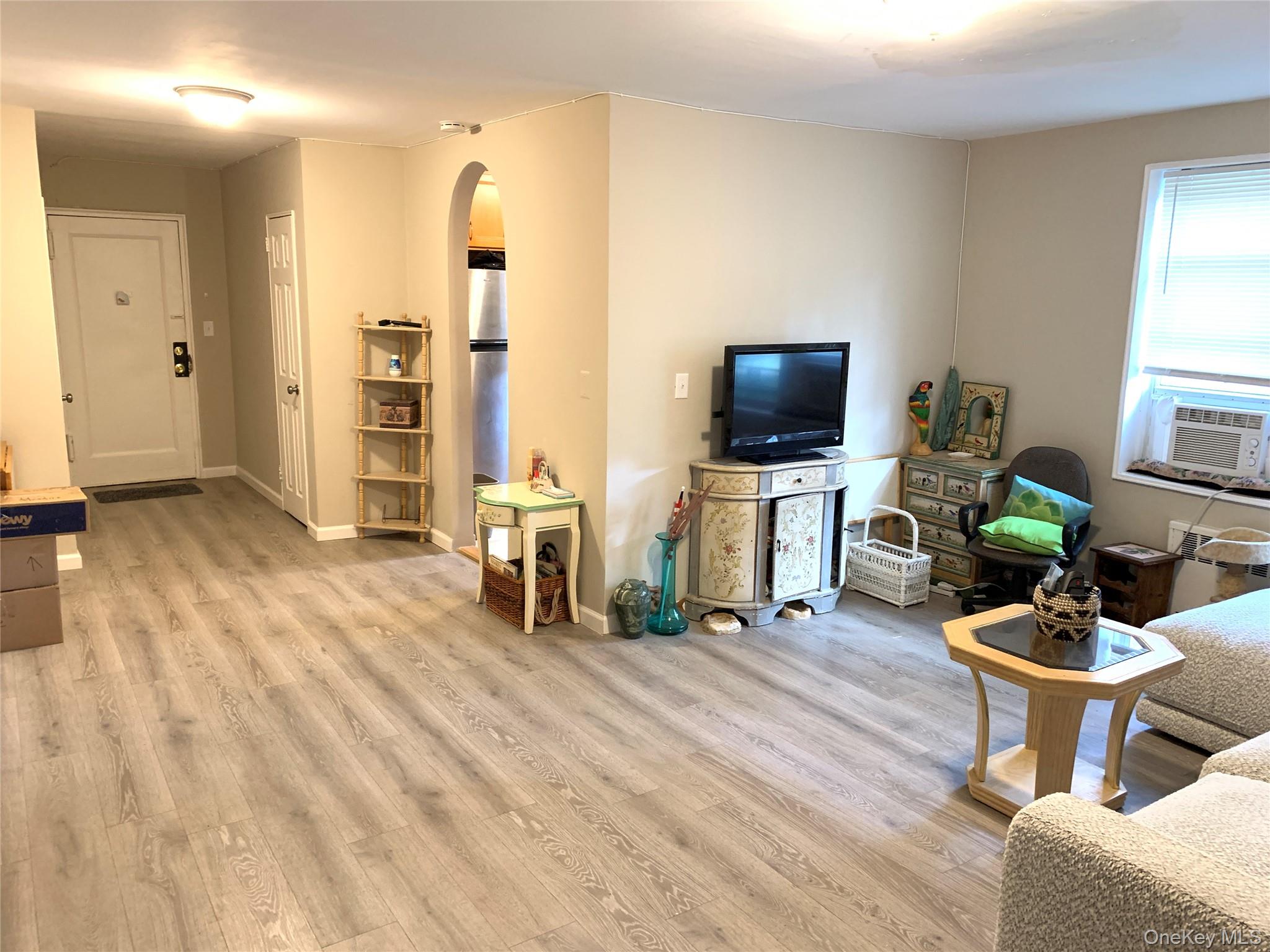 30 Davenport Avenue, Unit 1B New Rochelle, NY 10805 - Photo 9 of 16 a living room with furniture a flat screen tv and a window