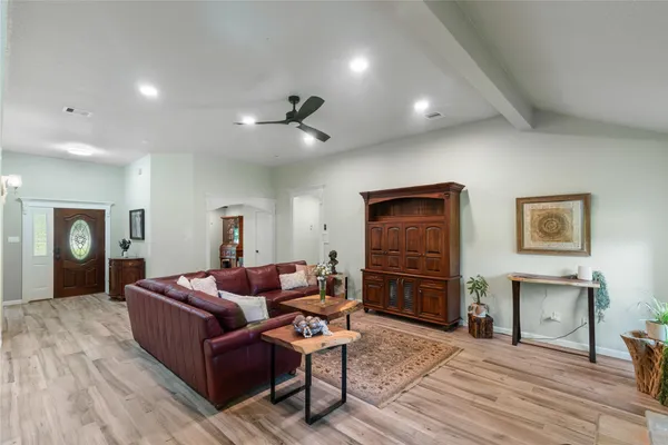 a living room with furniture and wooden floor