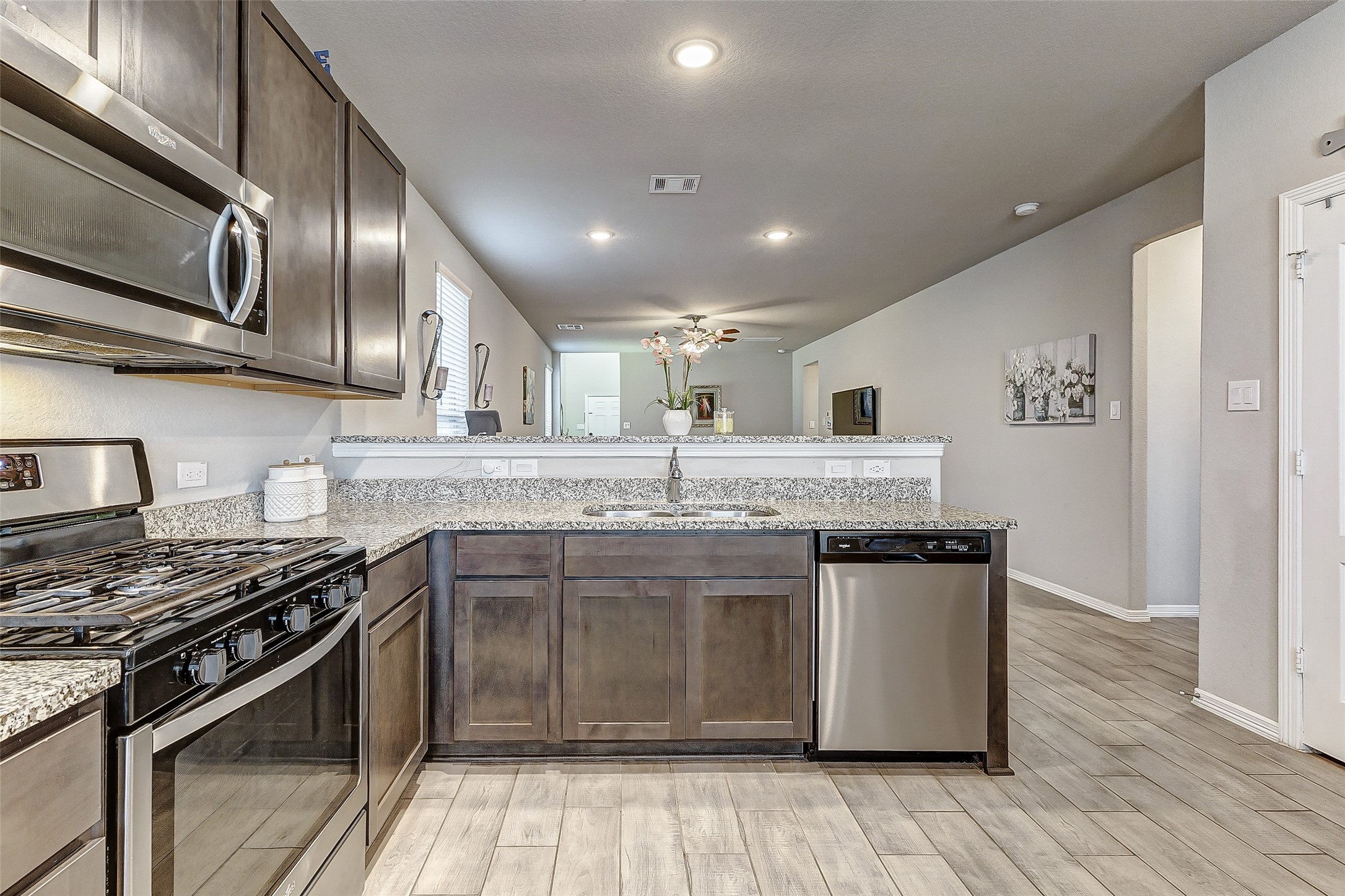 24715 Russet Bluff Trail Houston, TX 77336 - Photo 22 of 31 a kitchen with stainless steel appliances granite countertop a stove a sink and a microwave
