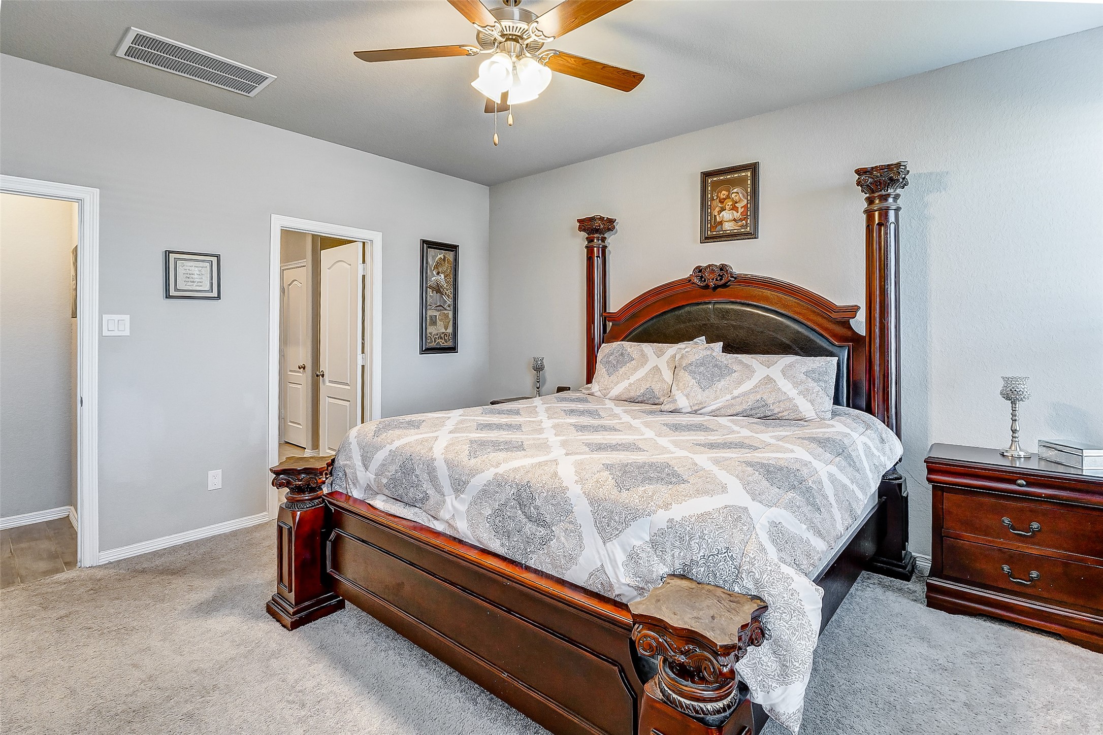 24715 Russet Bluff Trail Houston, TX 77336 - Photo 27 of 31 a bedroom with a bed and a chandelier