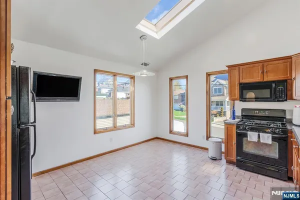 a view of a kitchen with an empty room and fire place
