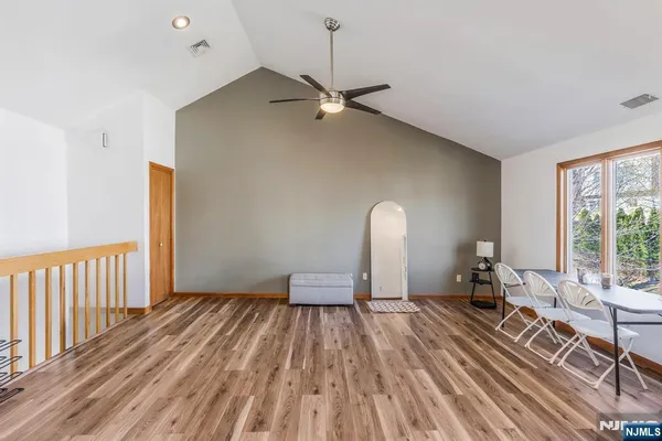 a view of a room with furniture and a window
