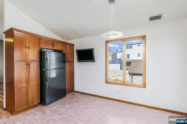 a kitchen with stainless steel appliances granite countertop a refrigerator and a microwave