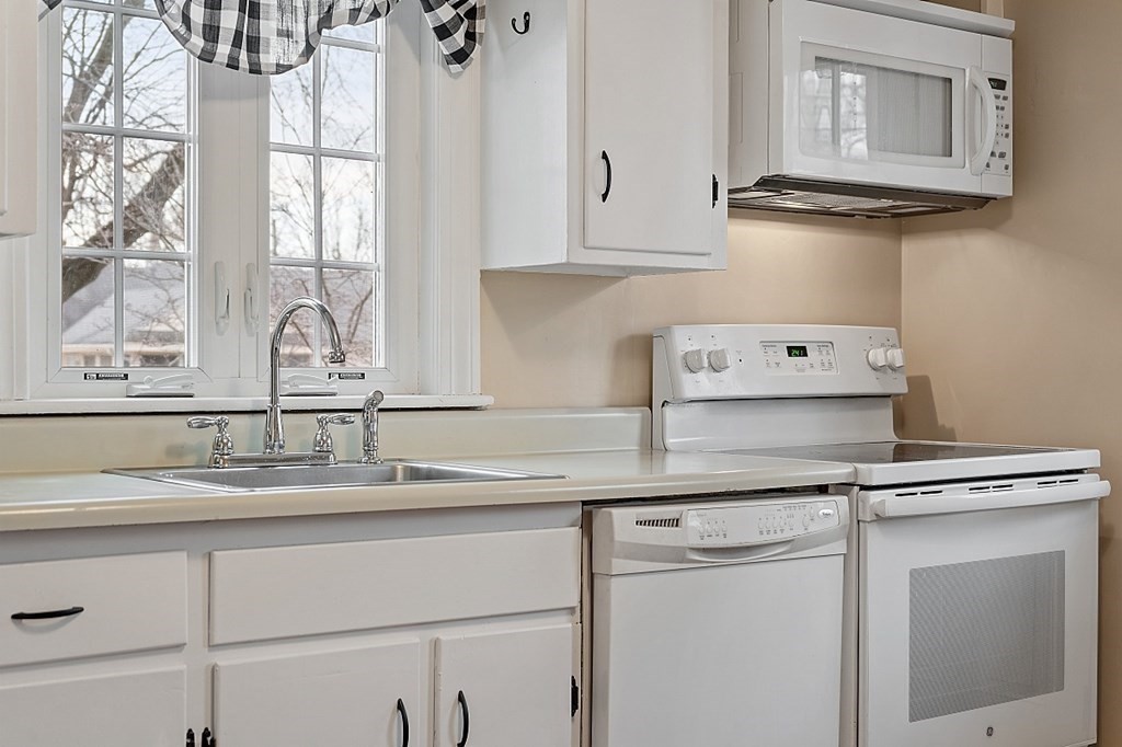 8 Gardner Road Reading, MA 01867 - Photo 13 of 35 a kitchen with granite countertop a sink and cabinets