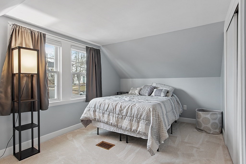 8 Gardner Road Reading, MA 01867 - Photo 23 of 35 a bed sitting in a bedroom next to a window