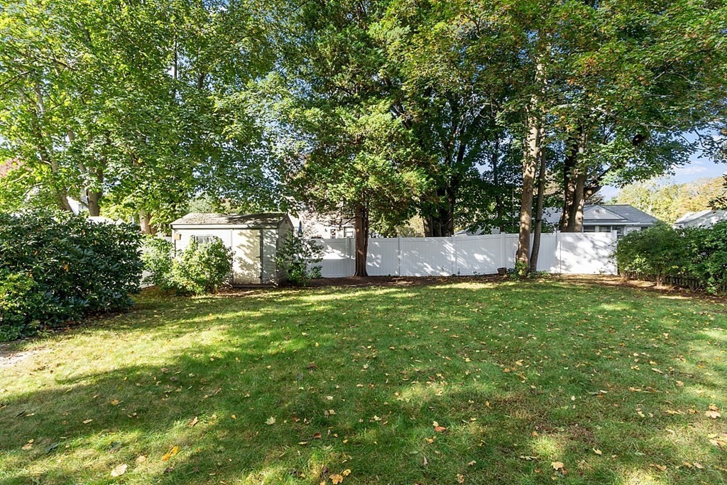 8 Gardner Road Reading, MA 01867 - Photo 32 of 35 a backyard of a house with plants and large trees