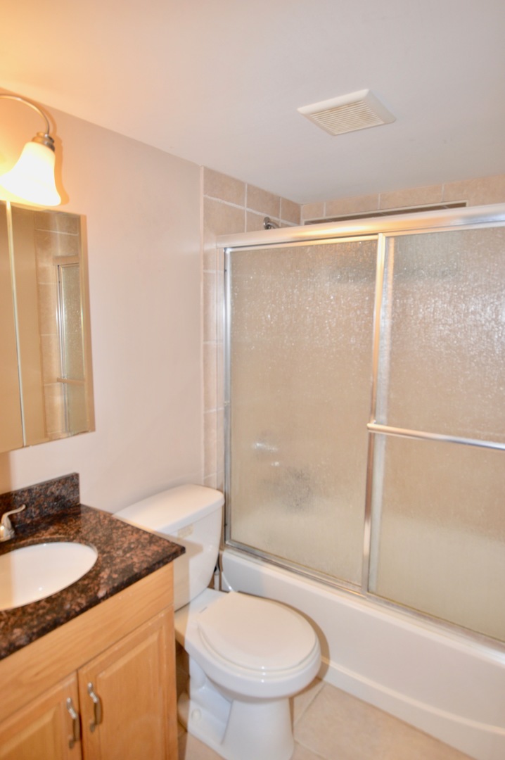 385 Willow Road Wauconda, IL 60084 - Photo 13 of 22 a bathroom with a granite countertop sink toilet and shower