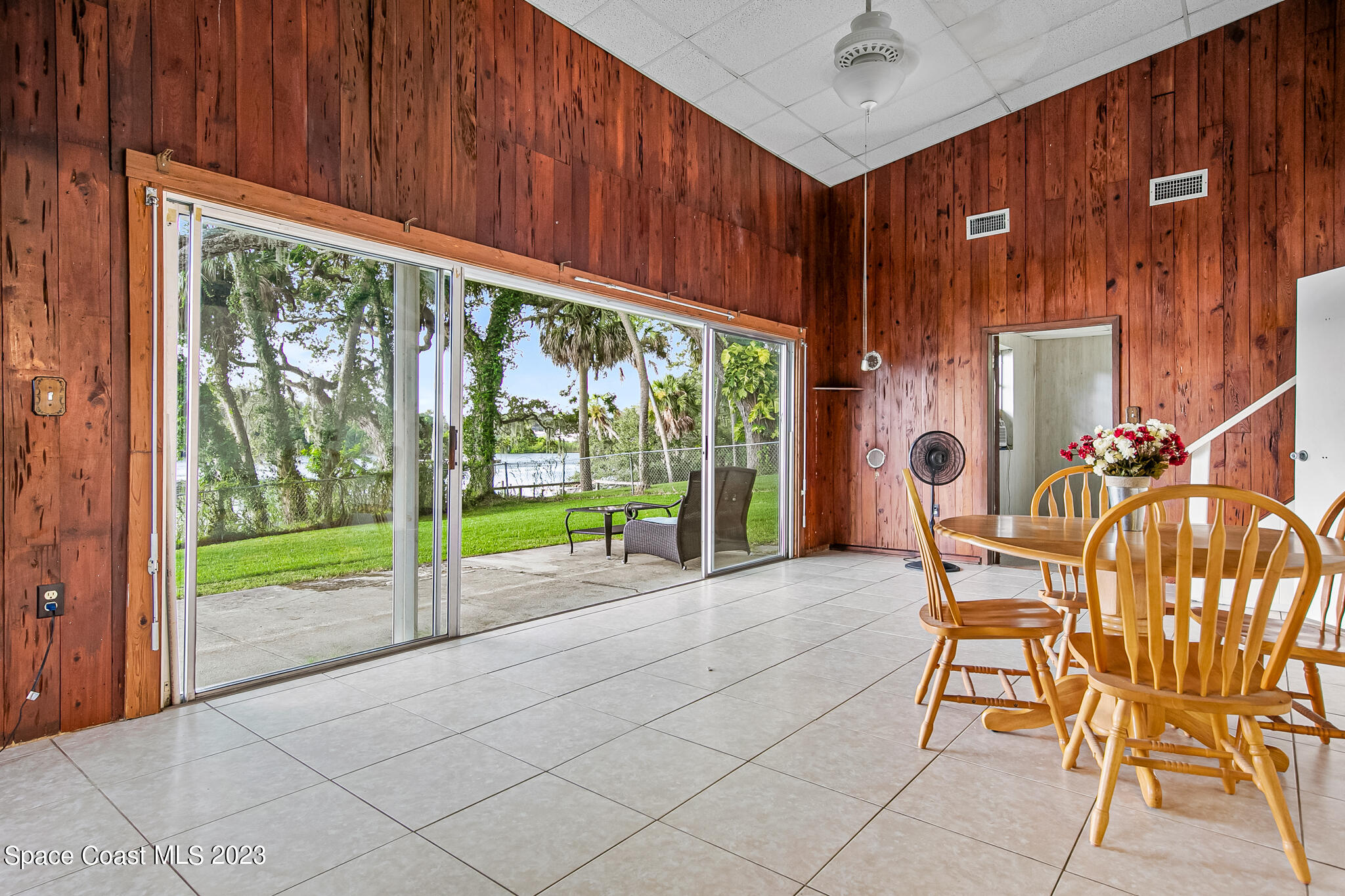 877 Sunset Drive Melbourne, FL 32935 - Photo 18 of 49 a view of a porch with chairs and backyard