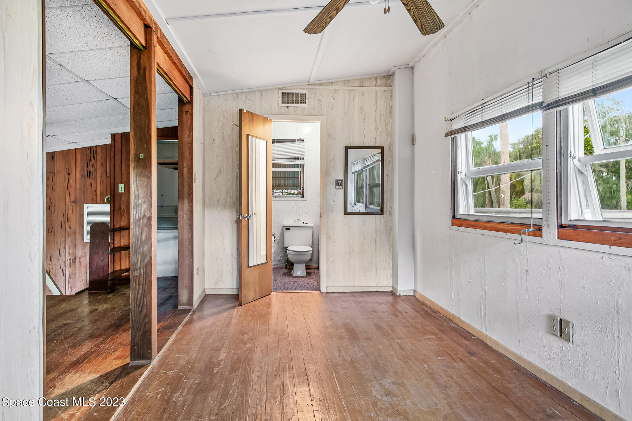 877 Sunset Drive Melbourne, FL 32935 - Photo 23 of 49 a view of an entryway with wooden floor and a window