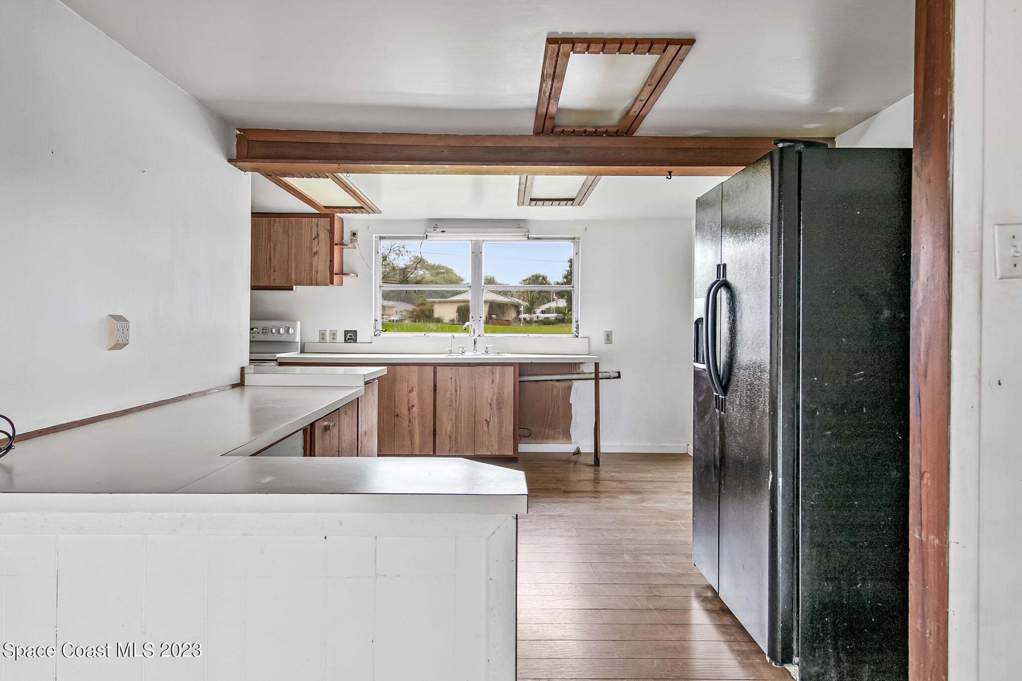 877 Sunset Drive Melbourne, FL 32935 - Photo 29 of 49 a kitchen with stainless steel appliances kitchen island granite countertop a refrigerator and a sink