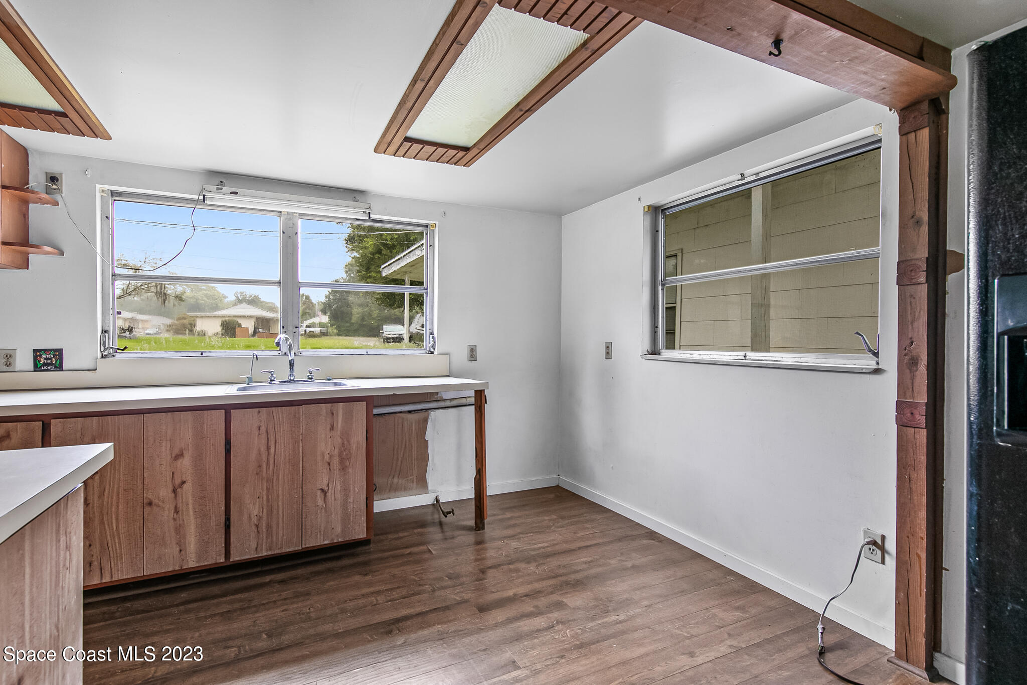 877 Sunset Drive Melbourne, FL 32935 - Photo 30 of 49 a kitchen with a sink and wooden floor