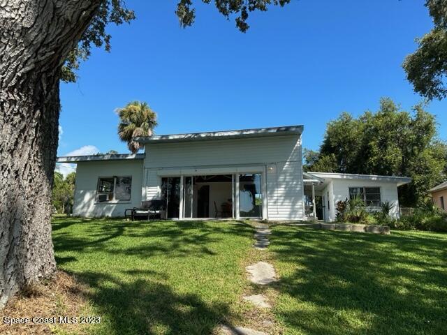 877 Sunset Drive Melbourne, FL 32935 - Photo 3 of 49 a front view of a house with a garden