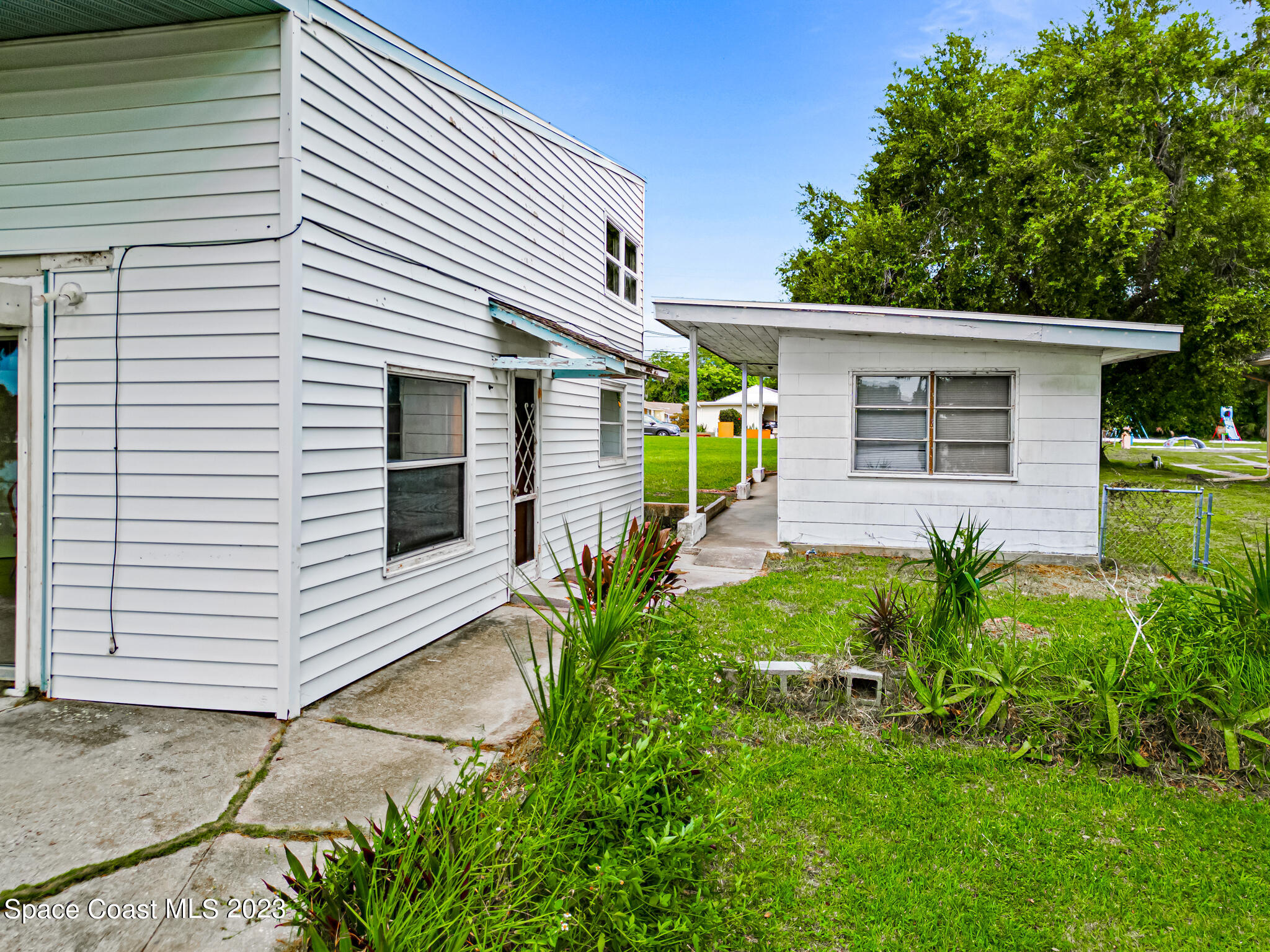 877 Sunset Drive Melbourne, FL 32935 - Photo 38 of 49 a front view of a house with garden