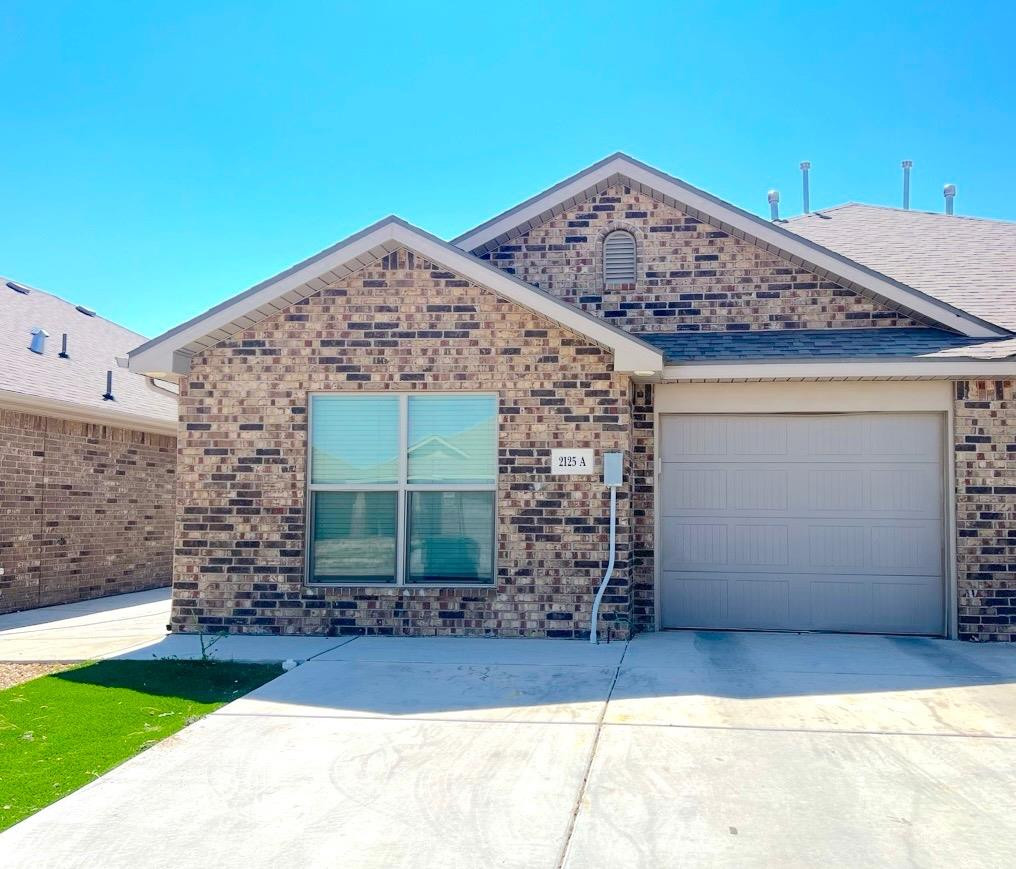 2125 North Texas Avenue, Unit B Lubbock, TX 79403 - Photo 1 of 21 a front view of a house with garden