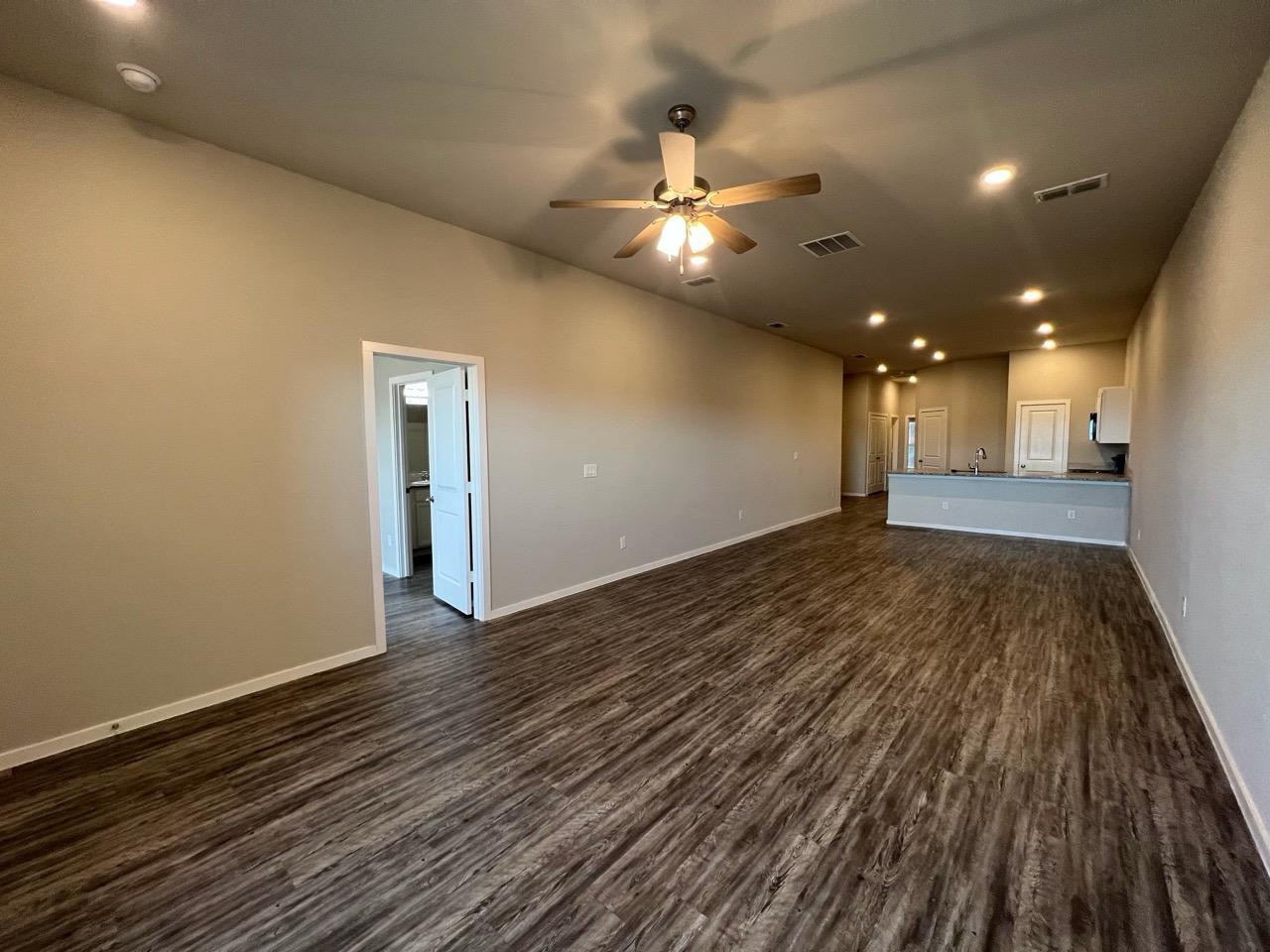 2125 North Texas Avenue, Unit B Lubbock, TX 79403 - Photo 20 of 21 wooden floor in an empty room with a window