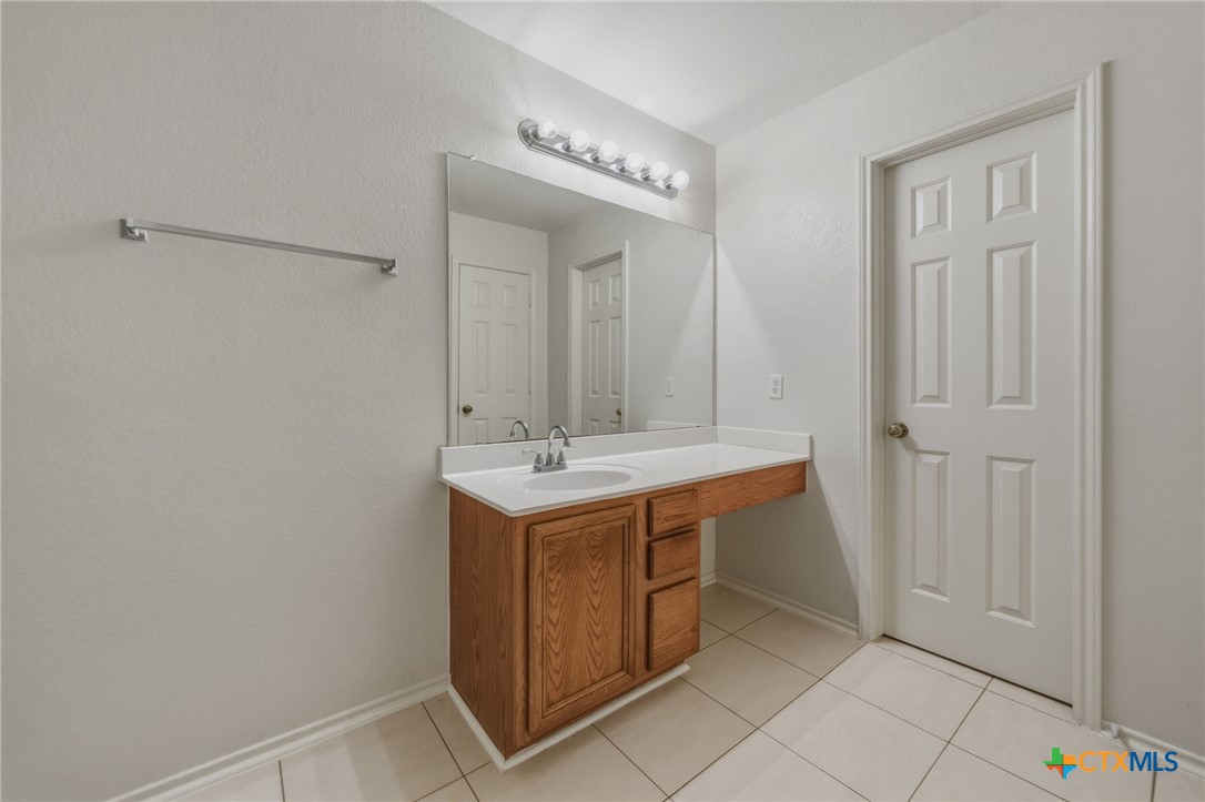 109 Comal Cove Elgin, TX 78621 - Photo 27 of 34 a utility room with a sink and a mirror