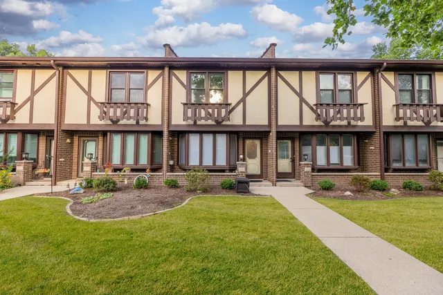 a front view of a house with swimming pool and porch