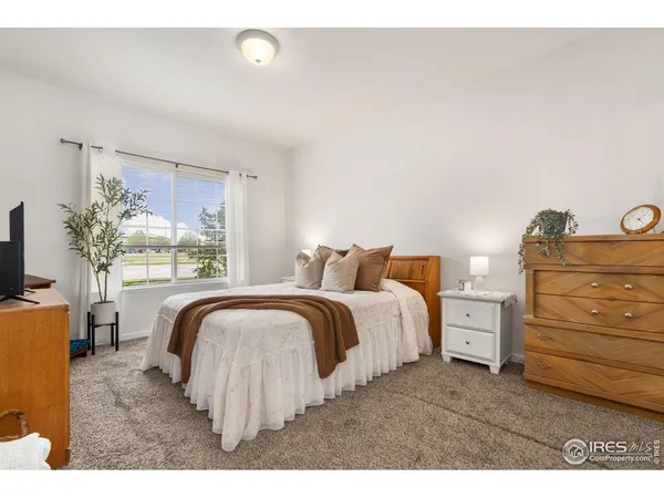 a bedroom with a bed and with furniture