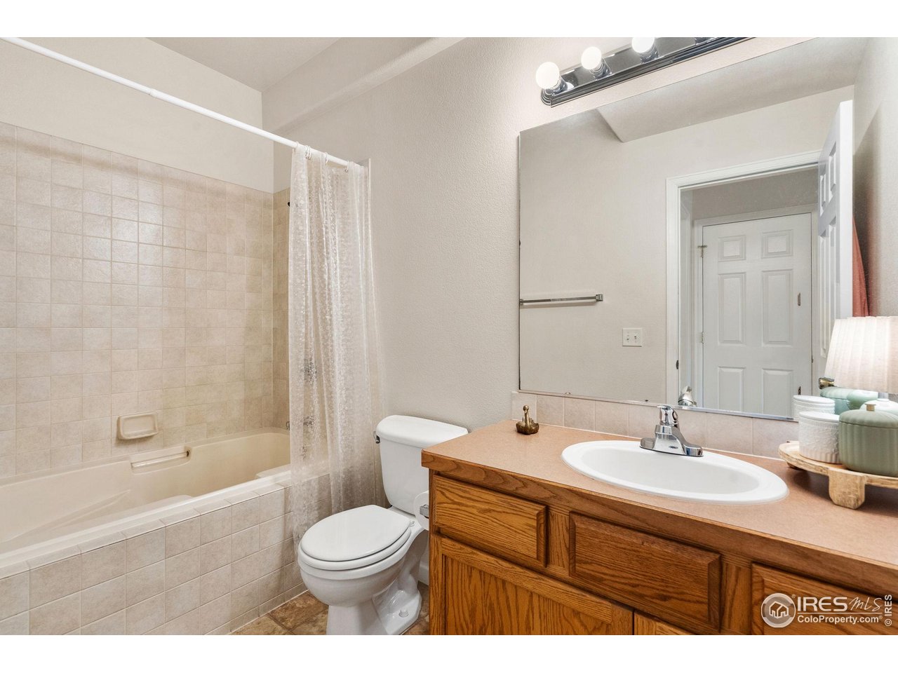 1343 Lake Circle, Unit B Windsor, CO 80550 - Photo 13 of 22 Primary bathroom is bright and private with a full tub and shower