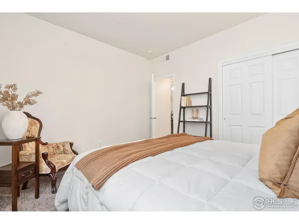 a bedroom with a bed and cabinets