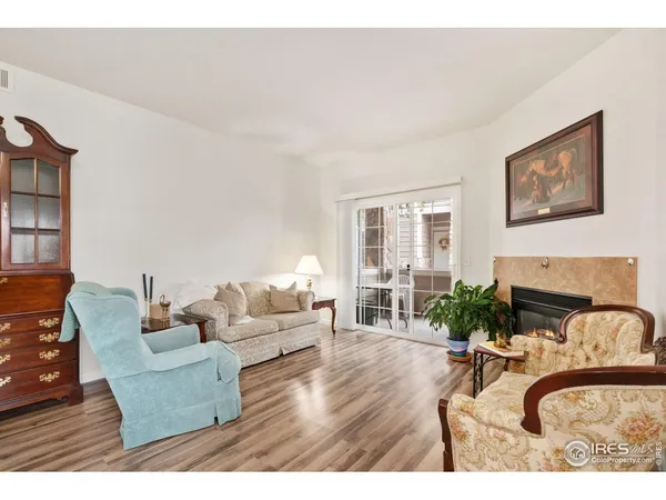 a living room with furniture a fireplace and a potted plant