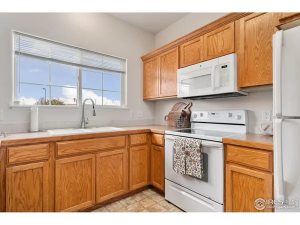 a kitchen with stainless steel appliances granite countertop a sink a stove and cabinets
