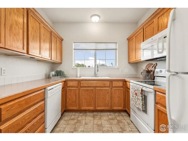 a kitchen with stainless steel appliances granite countertop a sink and cabinets