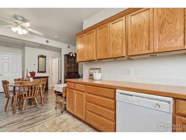 a kitchen with stainless steel appliances granite countertop a sink dishwasher and cabinets with wooden floor