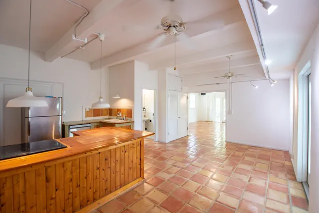 a view of a hallway with wooden shelves