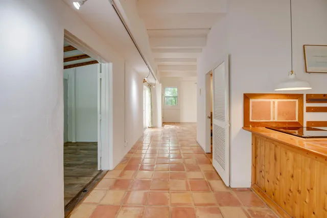 en empty room with wooden floor and windows