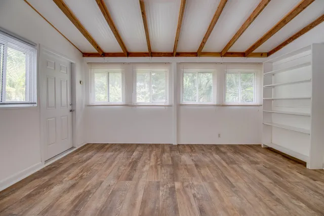 a view of balcony with wooden floor