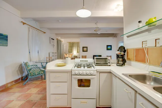 a kitchen that has a sink and a stove in it