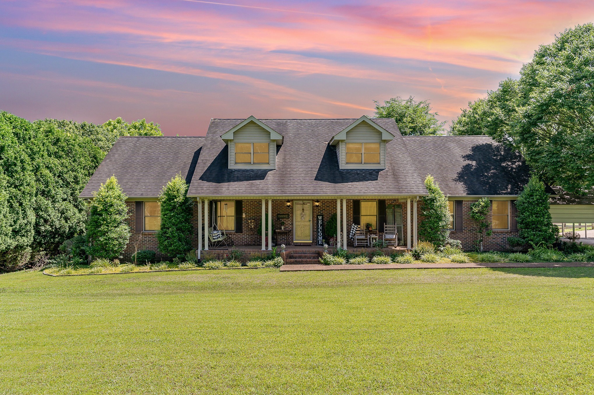 a front view of building with yard and green space