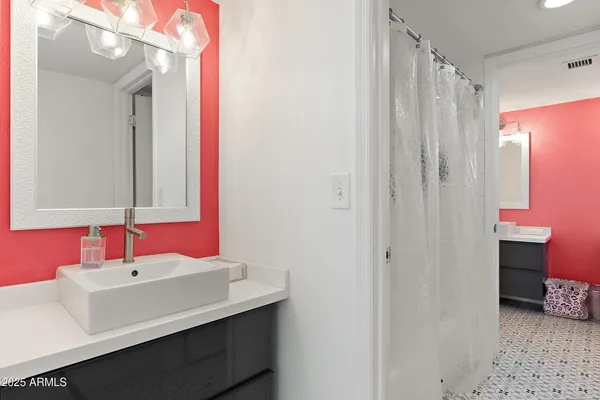 a bathroom with a sink vanity and a mirror