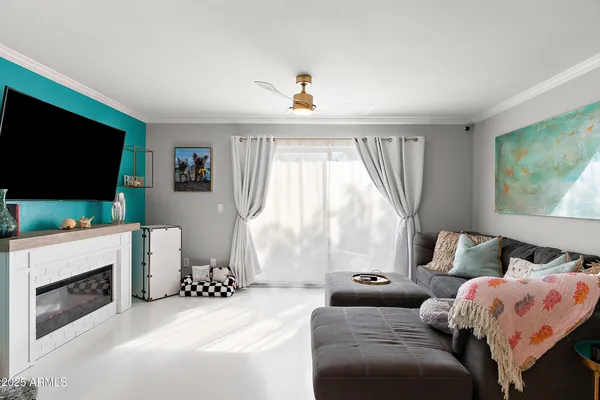 a bedroom with furniture and a flat screen tv