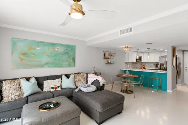 a living room with furniture and a open kitchen