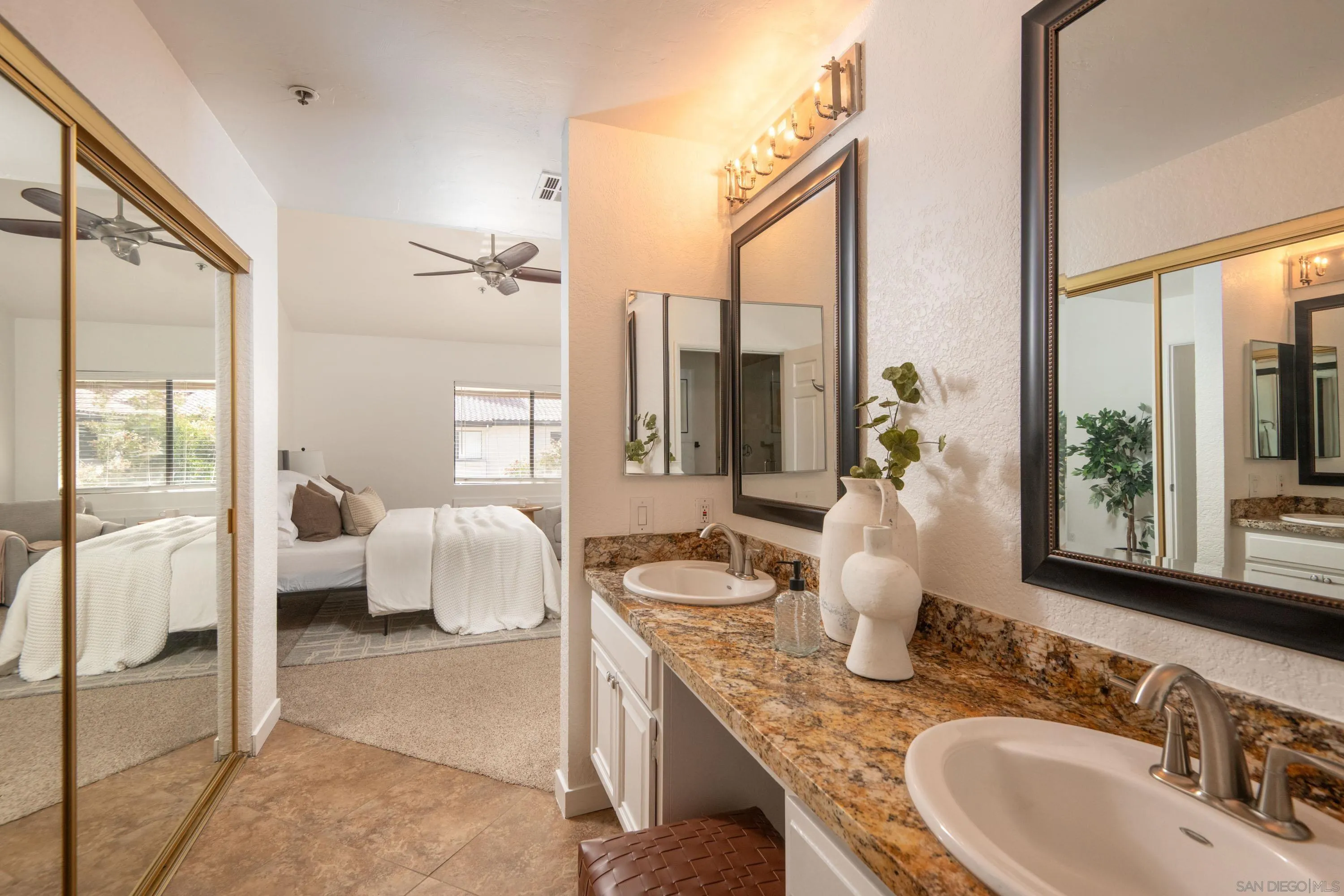 5705 Friars Road, Unit 54 San Diego, CA 92110 - Photo 18 of 30 a en suite spacious bathroom with a granite countertop double vanity mirror and a bathtub