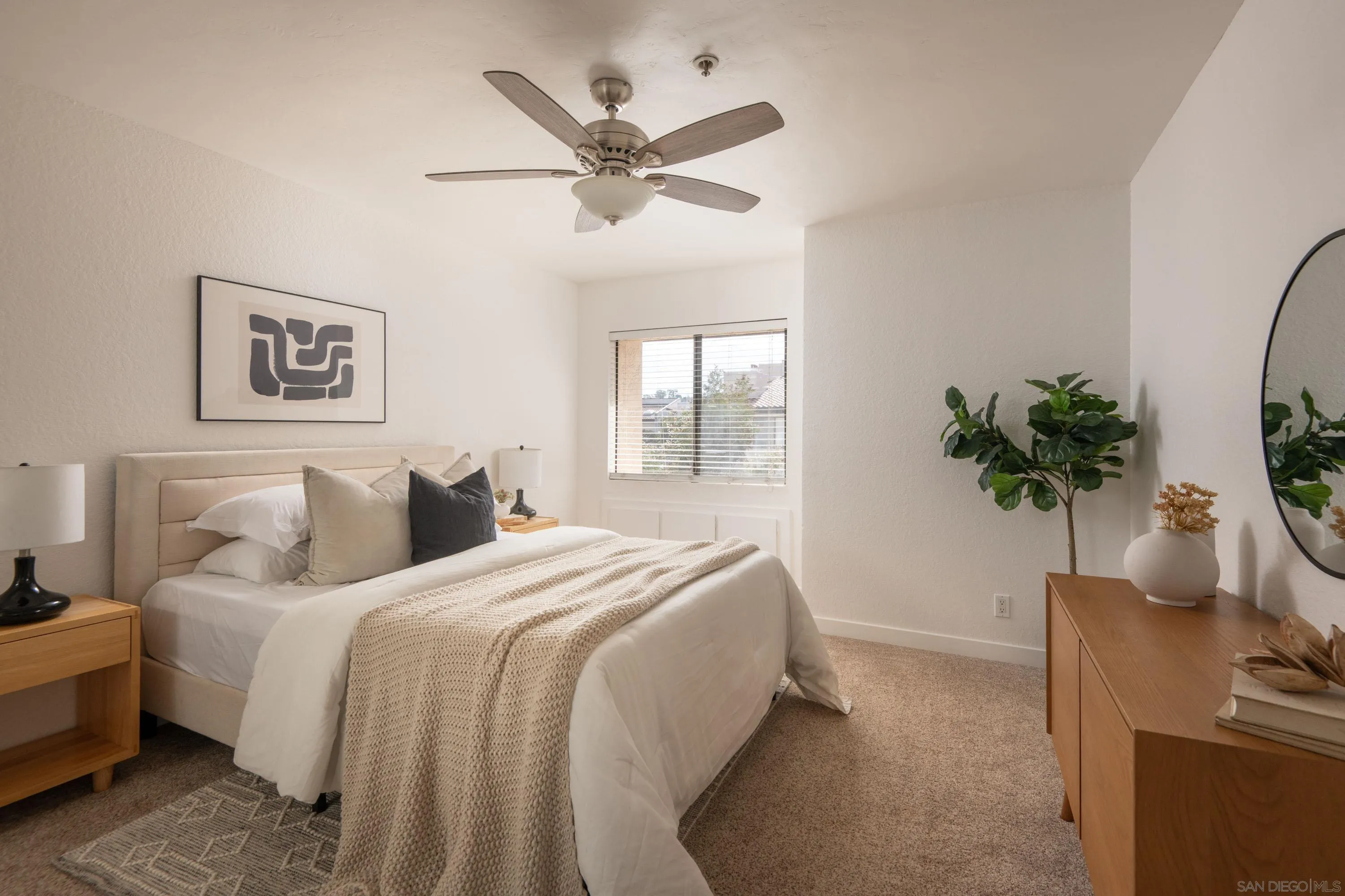 5705 Friars Road, Unit 54 San Diego, CA 92110 - Photo 19 of 30 a bedroom with a bed and a potted plant