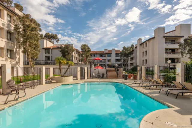 a view of a swimming pool with a patio and a yard