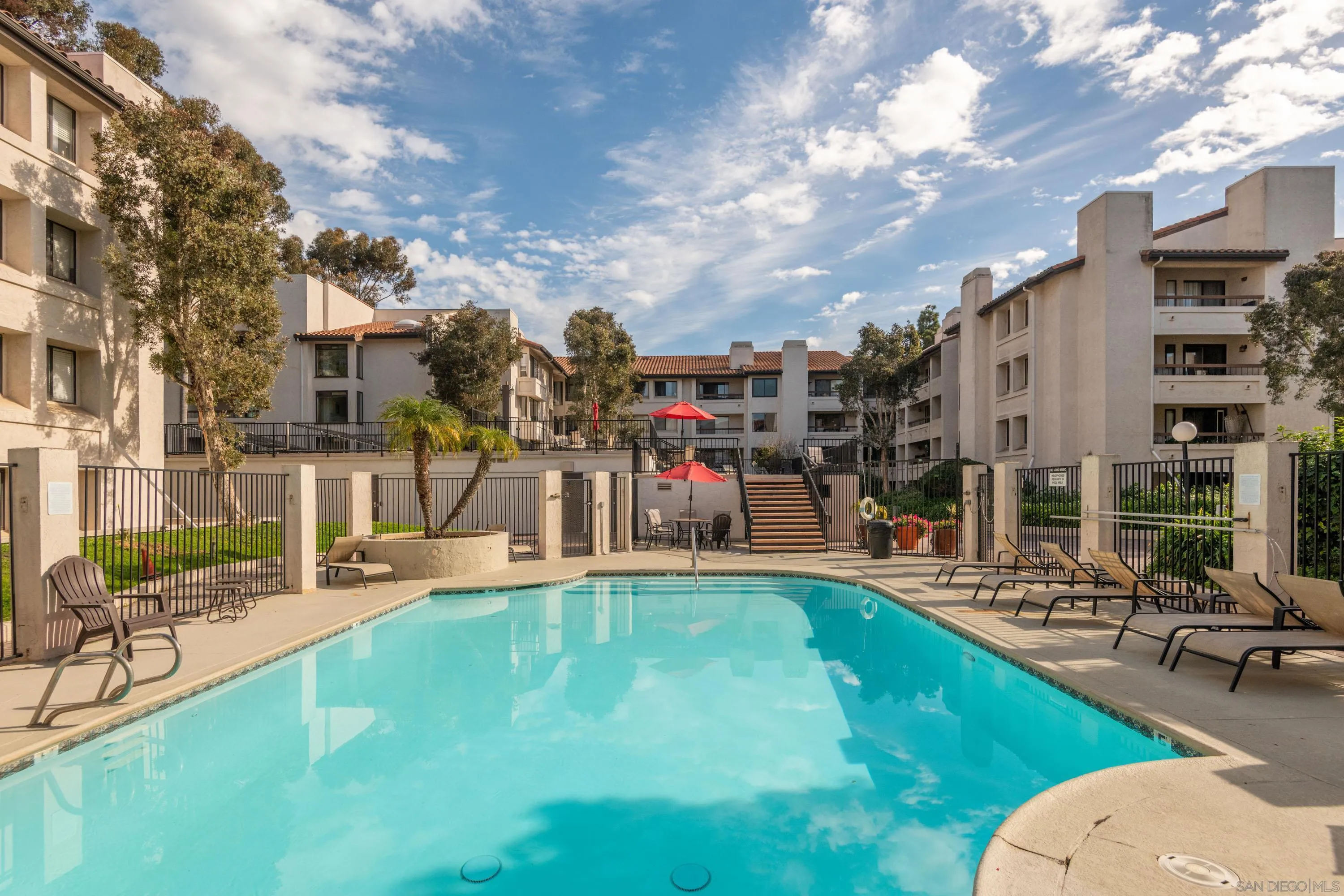 5705 Friars Road, Unit 54 San Diego, CA 92110 - Photo 2 of 30 a view of a swimming pool with a patio and a yard
