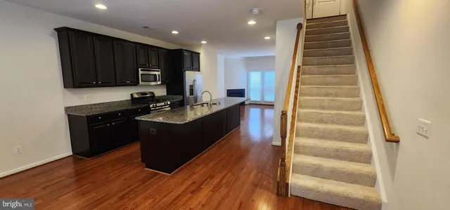a kitchen with a sink and a refrigerator