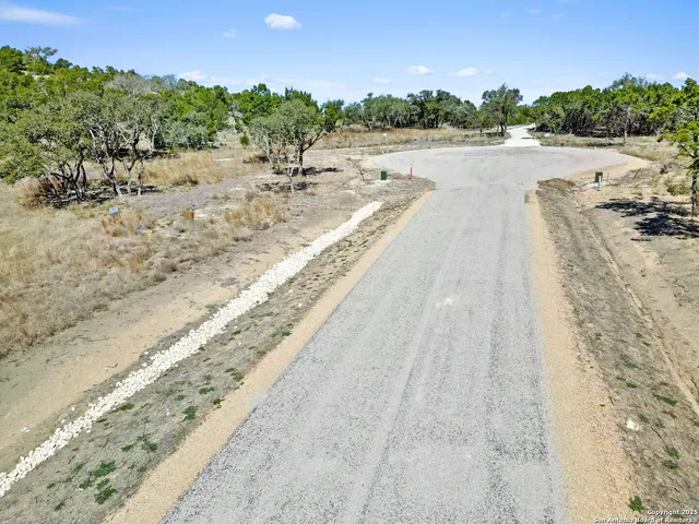 a view of a lake with trees and houses in the background