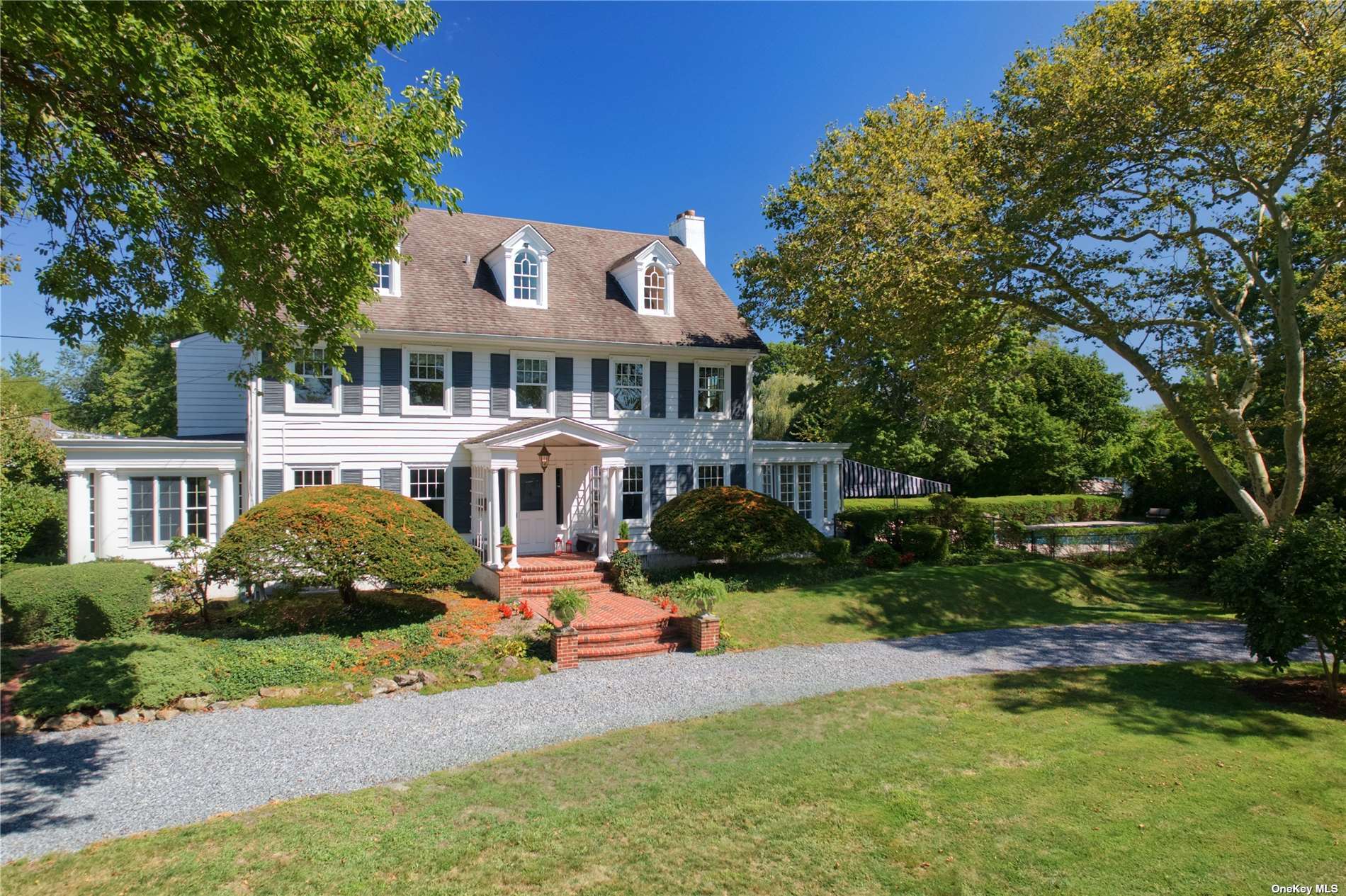 109 West Islip Road West Islip, NY 11795 - Photo 1 of 27 a front view of a house with a yard table and chairs