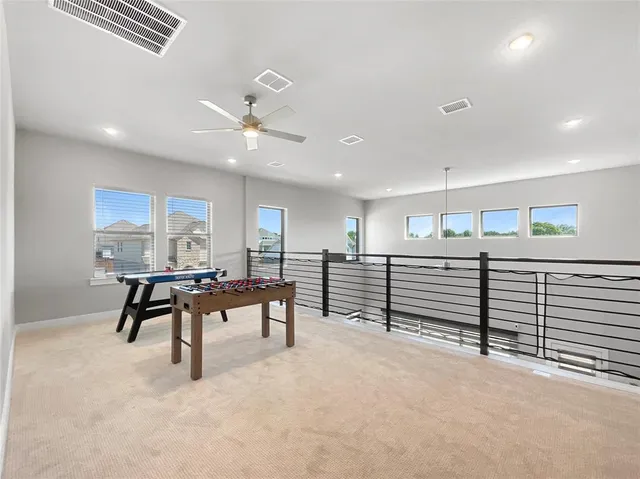 a dining room with furniture and a large window