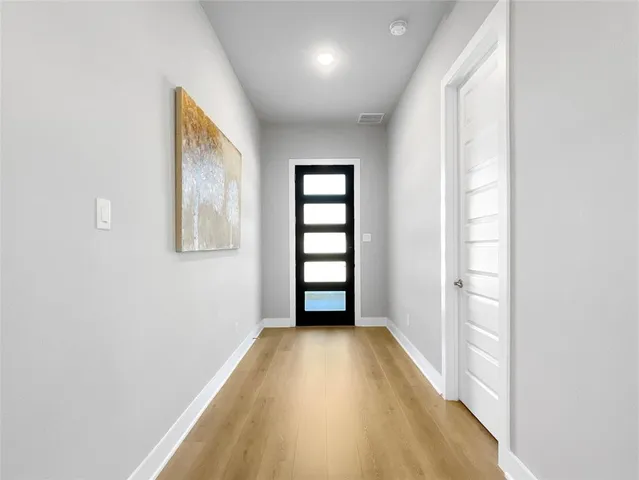 an empty room with windows and closet