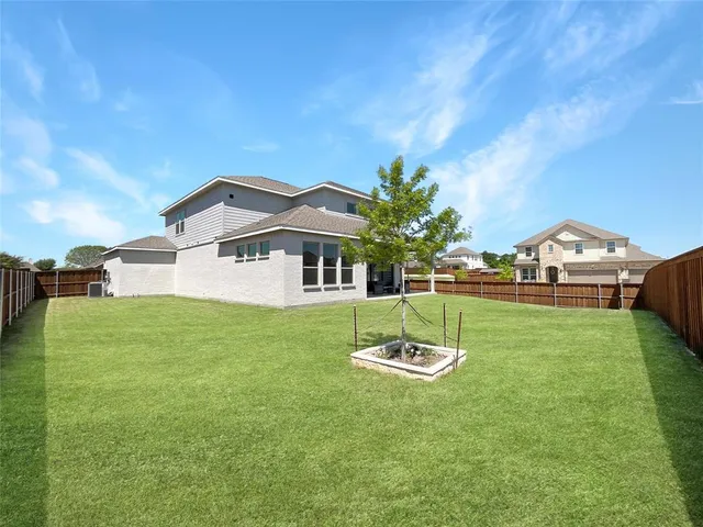 a front view of house with yard barbeque oven and green space