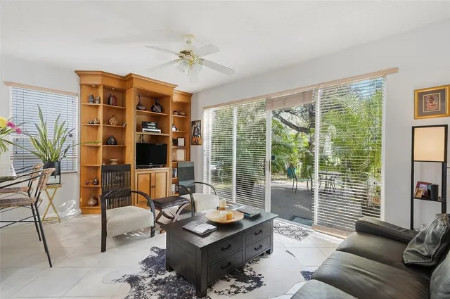 a living room with furniture and large windows