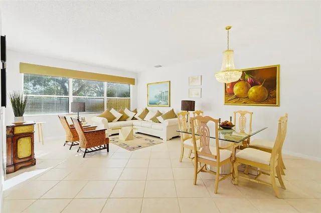 a living room with fireplace furniture and a potted plant
