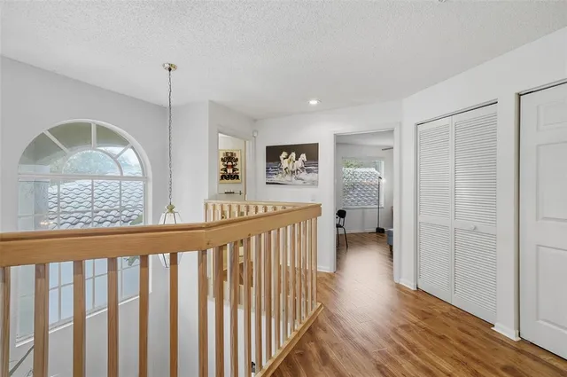 a view of a hallway view with wooden floor and staircase