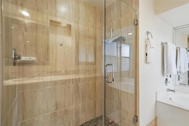 a bathroom with a shower and a sink
